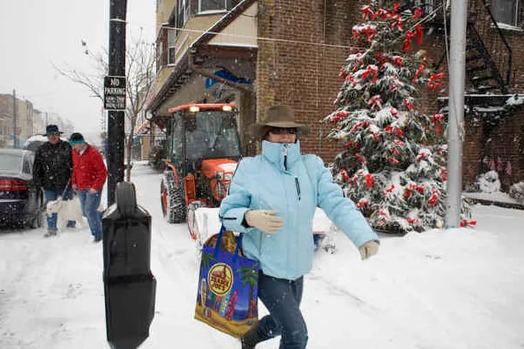 Caroline Talarico of Media runs ahead of a plow cleaning the sidewalk on State Street. She was out doing holiday errands yesterday. &quot;I just love this,&quot; she said.