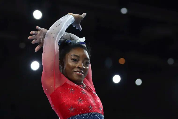 Simone Biles of the U.S. performs on the floor during women's team final at the Gymnastics World Championships in Stuttgart, Germany, Tuesday, Oct. 8, 2019. (AP Photo/Matthias Schrader)