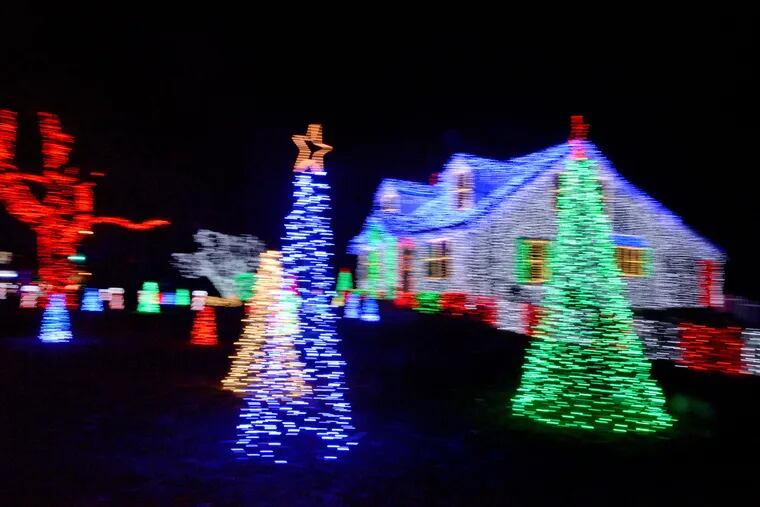  "One of the things I enjoy is helping people," Amber Merefield says. "People really enjoy it, and it has become a special part of their holiday tradition." (A slow camera shutter speed blurs the lights.)