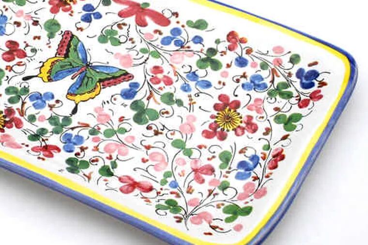 Brighten your table with a flutter of butterflies. This ceramic platter, handmade in Tuscany for Sur La Table, makes for a lovely presentation of appetizers or sweets. Microwave and dishwasher safe.