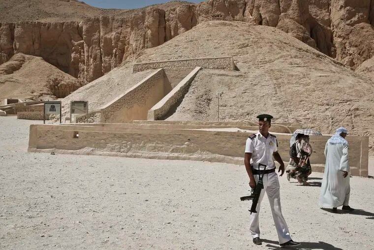 A policeman standing guard Tuesday as tourists walk past him outside the tomb of King Tutankhamun in Luxor. A top Egyptian official is seeking final approval for radar inspection of the tomb.