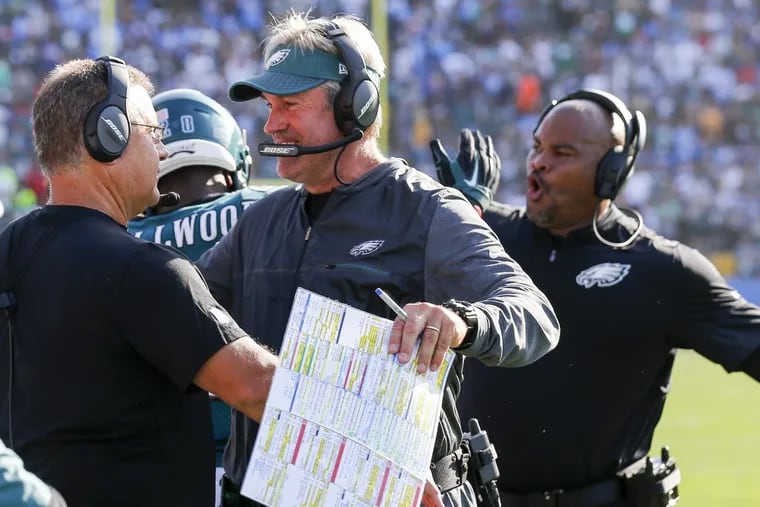 Eagles coach Doug Pederson celebrates with his coaches after a late first down Sunday against the Chargers.