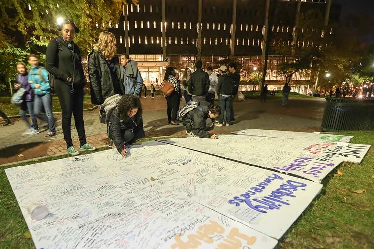 Penn students protest by signing a Wall of Solidarity or "Unity Wall" Friday.