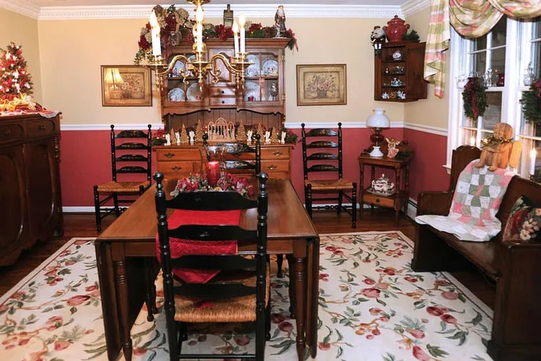 Christmas decor dominates in the dining room, above, and living room, below. Even the kitchen has a holiday tree, left. &quot;The real holiday begins at the moment when the kids and grandkids arrive, and we're together,&quot; Mary said. &quot;It's a little crowded, but it's a lot wonderful!&quot;