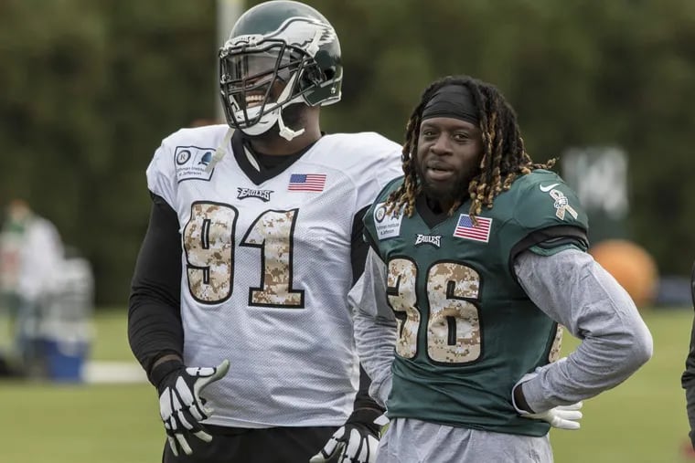 Eagles all-pro defensive tackle Fletcher Cox (left) with newly acquired running back Jay Ajayi at  practice.