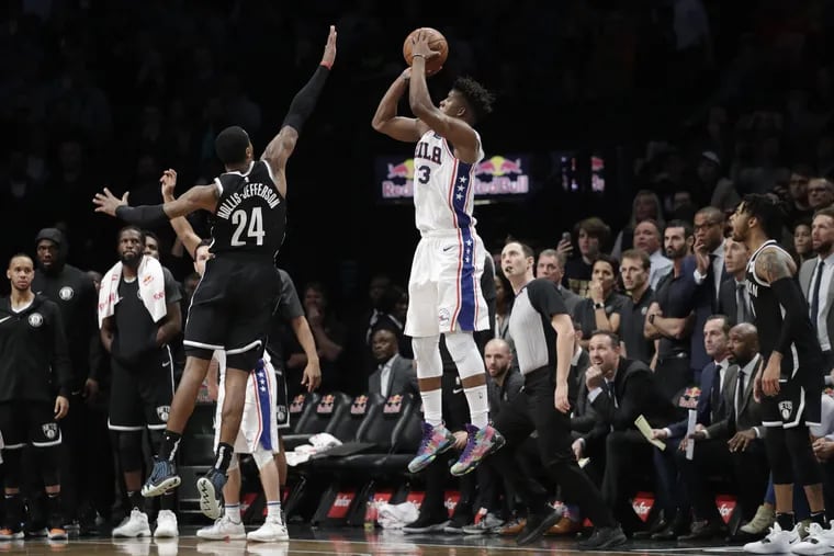 Jimmy Butler hits a game-winning three pointer over Rondae Hollis-Jefferson in Brooklyn on Sunday.