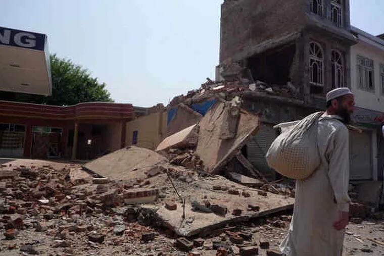 A man walks past destruction caused by fighting between Pakistani security forces and Taliban militants in Mingora, the Swat Valley's main town. Most residents had fled before the battle.