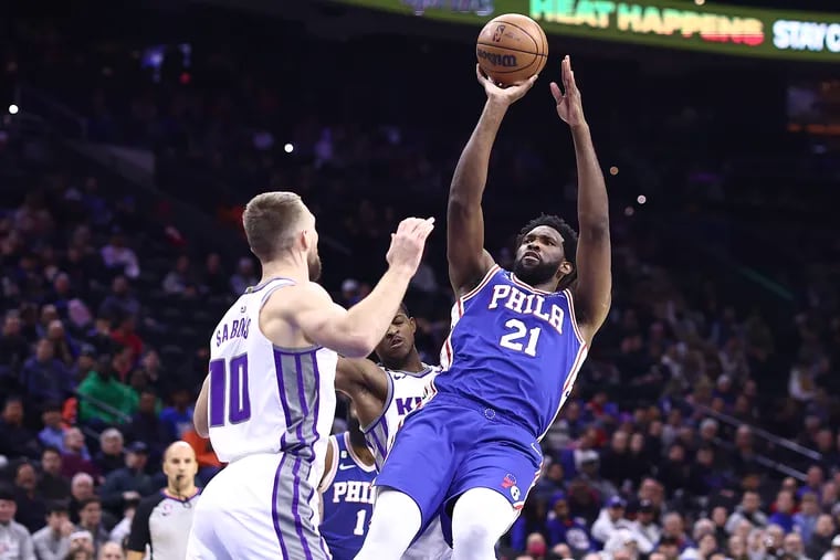 Joel Embiid (right) shoots a fadeaway jumper over Sacramento Kings center Domantas Sabonis (left) during a game last week at Wells Fargo Center. Embiid leads the NBA in scoring at 33.3 points per game going into Monday's home game against Toronto. (Photo by Tim Nwachukwu/Getty Images)