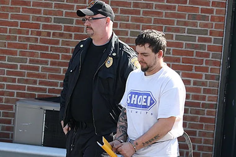 Walter Meyerle being led away after his arraignment in March at district court in Bristol Borough. (Larry King / Staff)