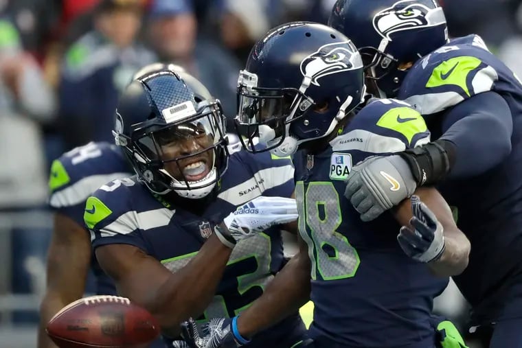 Seahawks wide receiver Jaron Brown (center) celebrates with wide receiver David Moore (left) and tackle Duane Brown after catching a touchdown pass against the 49ers in 2018. Duane Brown will not play against the Eagles. Jaron Brown is questionable.