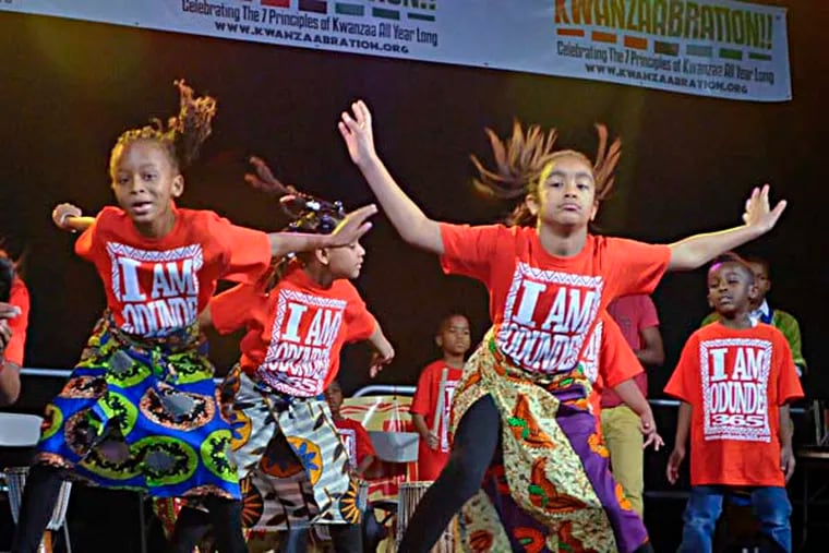 Members of the Odunde 365 childrens saturday dance class peform during Kwanzaabration, a Kwanza festival at Universal Audenried High School, put on by music legend Kenny Gamble and others.  RON TARVER / Staff Photographer ) December 28, 2013