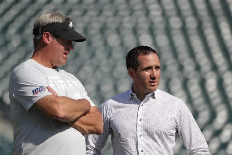 Eagles head coach Doug Pederson (left) talks with executive vice president Howie Roseman before a game earlier this season.