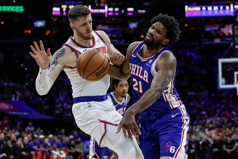 Sixers Joel Embiid is fouled by Knicks Isaiah Hartenstein during the first quarter of Game 3 of the NBA Eastern Conference playoffs at the Wells Fargo Center in Philadelphia on Thursday, April 25, 2024.
