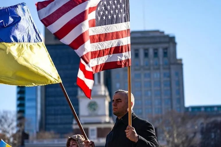 Tara Smerechanskyy, a Philadelphia resident and fourth-wave Ukrainian immigrant, holds American and Ukrainian flags at a recent pro-Ukraine rally at Independence Hall.