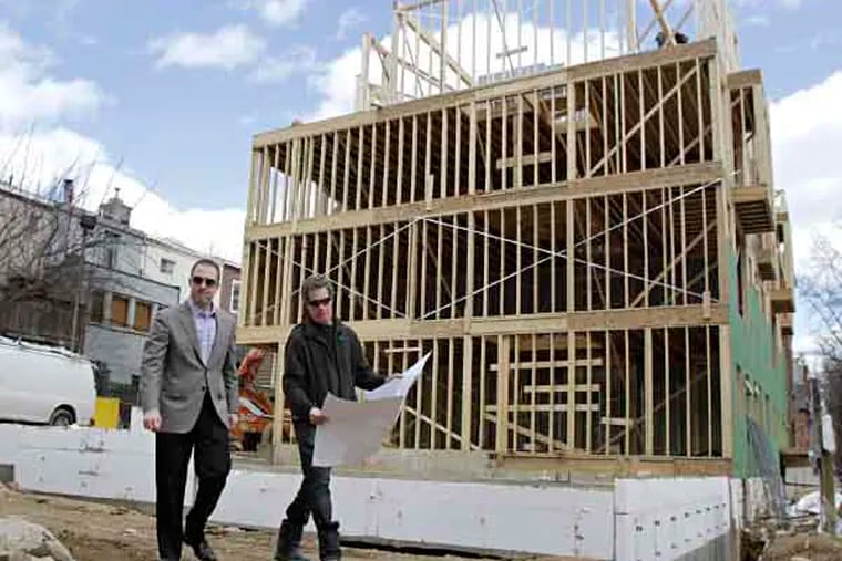 Developers Harvey (lright) and Noah Ostroff (father and son) inspect their project in the 1800 block of Lombard St. in Phila. where they are building 11 new homes on March 14, 2013.  ( ELIZABETH ROBERTSON / Staff Photographer )