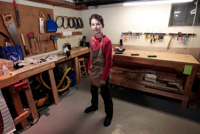 Mozi Weisenberg, 12, in his basement workshop.