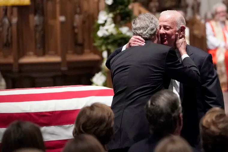 Former President George W. Bush embraces former Secretary of State James Baker, right, after he gave a eulogy during the funeral for former President George H.W. Bush at St. Martin's Episcopal Church, Thursday, Dec. 6, 2018, in Houston. (AP Photo/David J. Phillip, Pool)