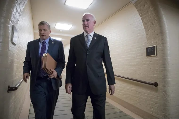 Retiring Rep. Charlie Dent, R-Pa., left, and Rep. Pat Meehan, R-Pa., walk to a meeting with fellow House Republicans last September.