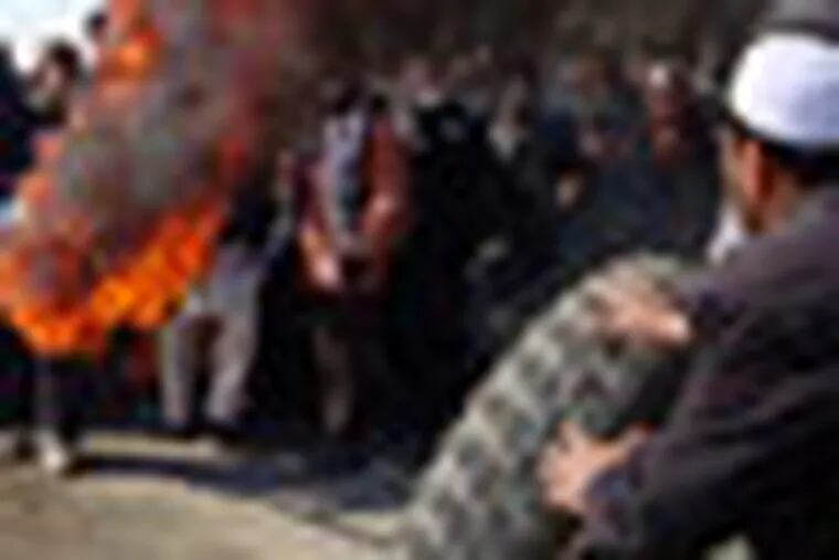 Afghans burn tires during an anti-U.S. demonstration over burning of Qurans at a US military base,  in Muhammad Agha, Logar province south of Kabul, Afghanistan, Saturday, Feb. 25, 2012. (AP Photo/Obaid Ormur)