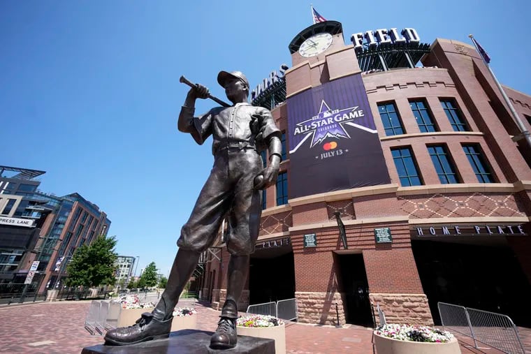 A banner for the All-Star game hangs on the front of Coors Field near the sculpture "The Player." Denver is hosting the Home Run Derby for just the second time since it began in 1985.