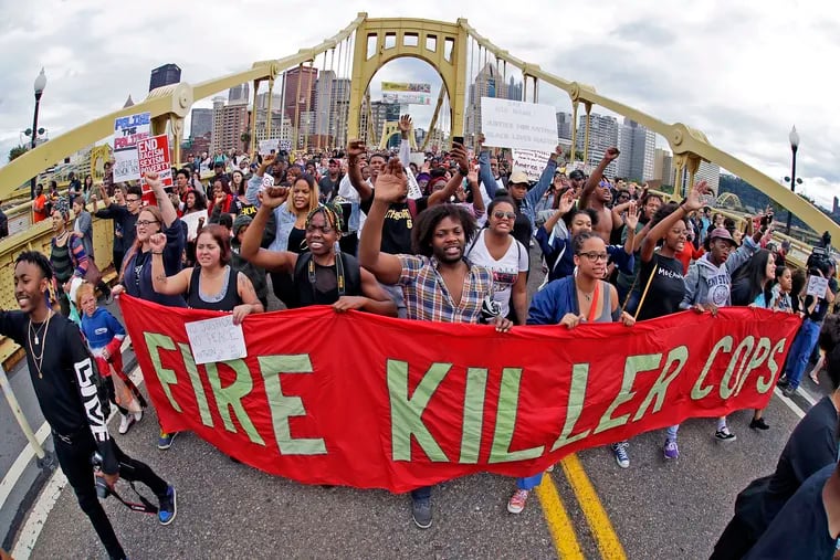 Demonstrators protesting the fatal police shooting of Antwon Rose II march across Pittsburgh's Roberto Clemente Bridge in June 2018. The death of Rose, who was unarmed as he fled during a traffic stop, sparked calls for increased police accountability.