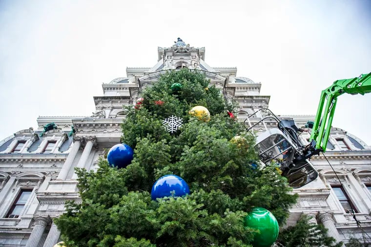 A crew from Proof Productions decorate the City's holiday tree at City Hall in Philadelphia, Pa, on Nov. 22, 2019. Ornaments includes colorful holiday balls, sleds, Christmas stockings, snowmen and snowflakes.
