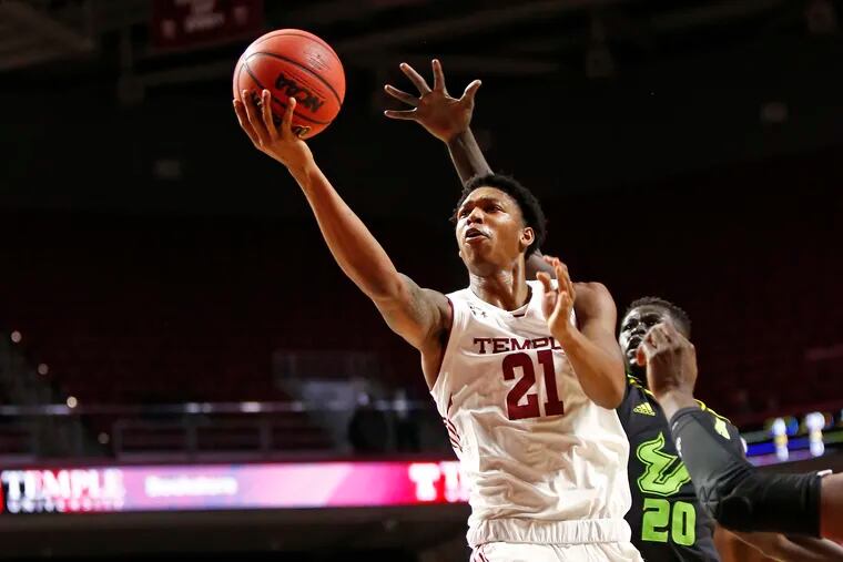 Justyn Hamilton of Temple shoots and is fouled by Mayan Kiir of South Florida in the first half of an American Athletic Conference basketball game Saturday at the Liacouras Center.