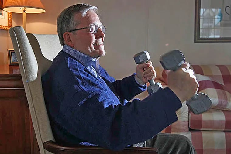 Bob Marshall uses dumbbells to build up his strength as part of his home therapy. Hard work has been the key to the many successes in his life, including recovery from a major illness.