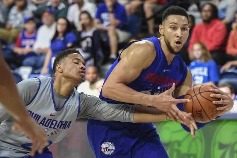 Markelle Fultz  tries to poke the ball away from fellow rookie Ben Simmons