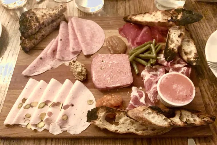 This charcuterie platter from Royal Boucherie includes (counter clockwise from top left) salami cotto, mortadella, country pÃ¢tÃ© with pork liver and bacon, coppa and bresaola, with chicken liver mousse in the ramekin. It's accompanied by pickled beans, 24 hour-roasted apple sauce, grain mustard, and pawpaw jam.
