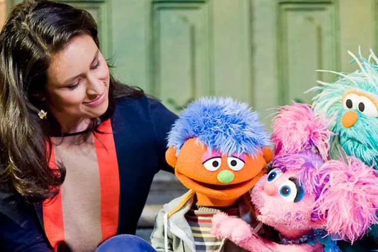 Alex (second from left), a Sesame Street character whose father is incarcerated, gets comforted by friends. A new Sesame Street initiative aims to help children of incarcerated parents cope, and provide resources for guardians.