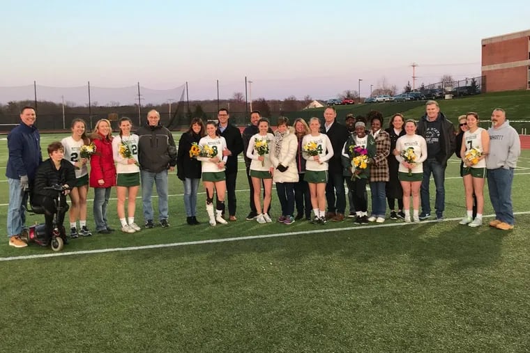 The Methacton girls’ lacrosse seniors pose for a picture with their parents on Senior Night.