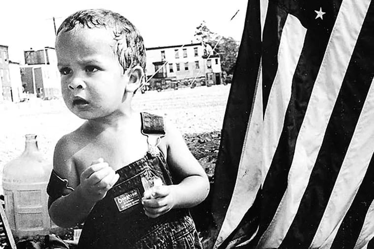 Always with us: A child on the site of a tent city built in 1995 at the former Quaker Lace Factory in Kensington. HARVEY FINKLE