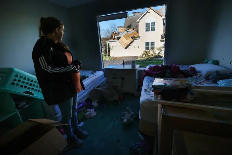 Kristin Bevilacqua-Nowell shows an Inquirer Reporter and photographer the room where her children were sleeping when the wind blew a window outward from the home onto the ground, at her home on Chelsea Court in Thornbury Township.