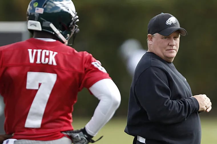 Eagles quarterback Michael Vick and head coach Chip Kelly. (David Maialetti/Staff Photographer)