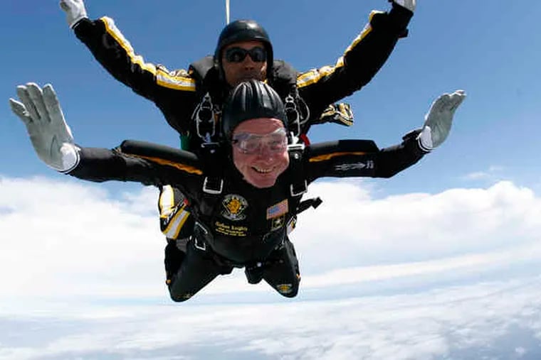 Former President George H. W. Bush rides with Sgt. First Class Mike Elliott of the Army Golden Knights parachute team as they zoom downward over his hometown of Kennebunkport, Maine, to celebrate his 85th birthday. &quot;It was a great day in the air,&quot; he quipped later.