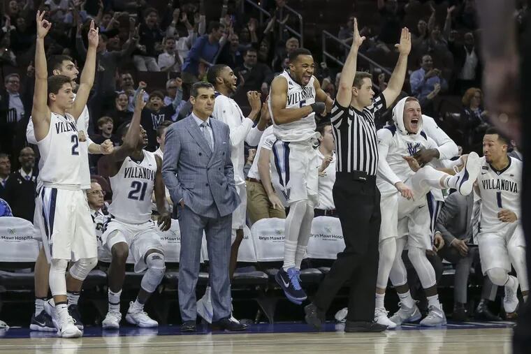 Villanova’s bench celebrates against DePaul as coach Jay Wright watches the action on Feb. 21.