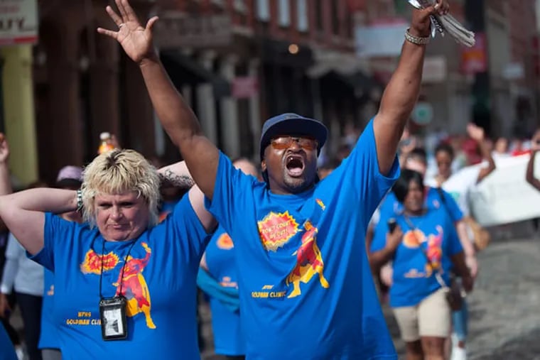 Dream Jackson cheers as he crosses the finish line on Chestnut Street during the fifth annual Recovery Walks! in Center City on Saturday, Sept. 19, 2015. (TRACIE VAN AUKEN/For The Inquirer)