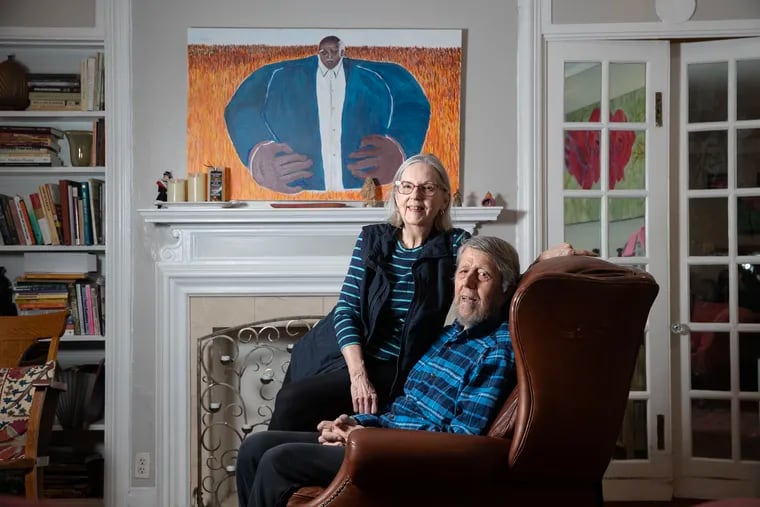 David Simon Greene and his wife Janet Wells Greene met at a liberation school for coal miners in West Virginia. Together, they founded and worked in liberation schools in New York City and Ohio. The painting above them is of Charlie Clayborn, who fought for coal miners rights for 50 years. They are shown on March 1, 2024.