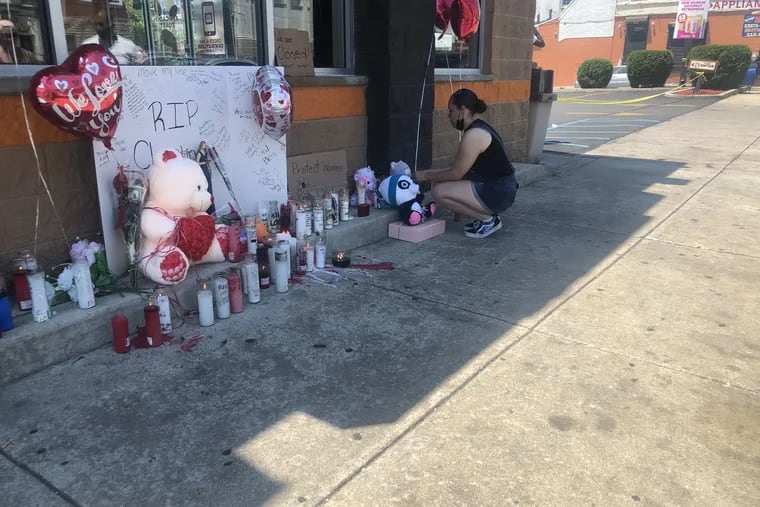 A memorial grew Sunday outside the Dunkin' Donuts at Lehigh Avenue and Fairhill Street in North Philadelphia where manager Christine Lugo was shot to death early Saturday morning during a robbery after she opened up. Paying her respects was a manager from another Dunkin Donuts who only wanted to be identified as Tatyanna.