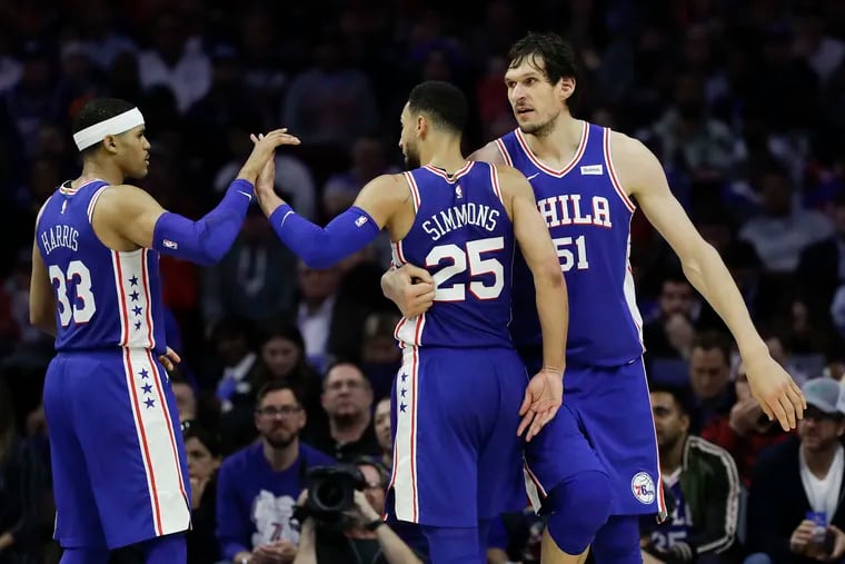 Ben Simmons, who had a triple-double on Monday, celebrates with teammates Tobias Harris and Boban Marjanovic during the fourth quarter of the Sixers' 145-123 win over the Nets in Game 2.