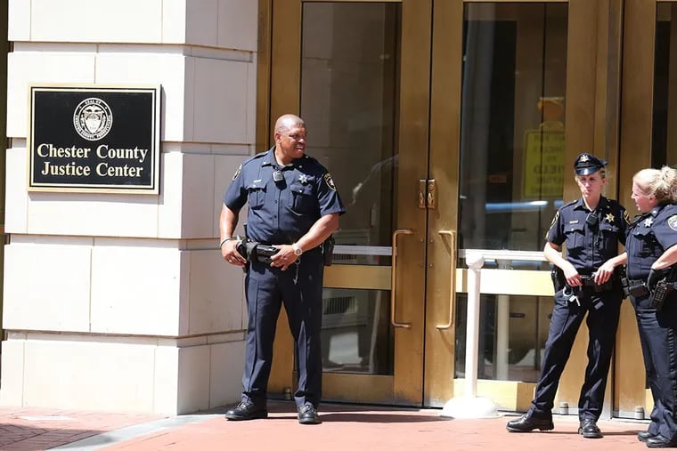 Police and sheriff personnel outside the Chester County Justice Center on Tuesday, Aug. 25, 2015. (DAVID SWANSON/Staff Photographer)