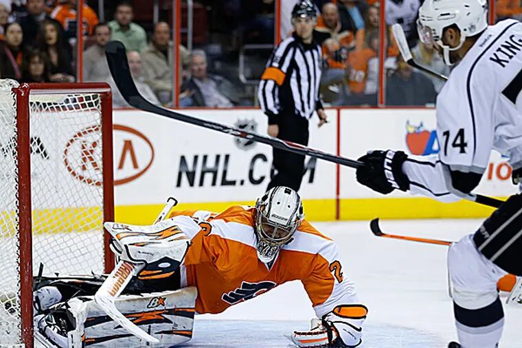 The Flyers' Ray Emery cannot block a shot by the Kings' Dwight King during the third period. (Matt Slocum/AP)