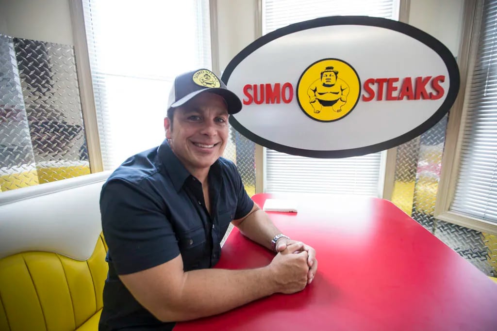 Billy Creagh, co-founder of Sumo Steaks, poses for a photo upstairs at Sumo Steaks. ( Colin Kerrigan / Philly.com )