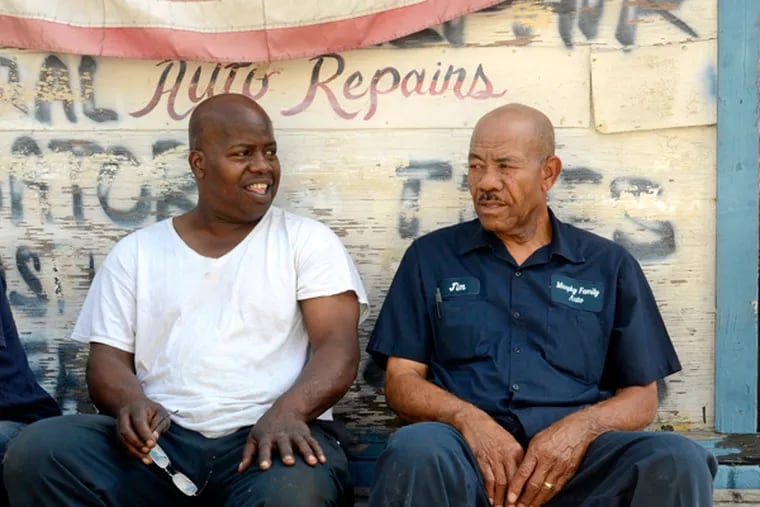 Jimmie Murphy (right) and his mechanic of 32 years Larry Powell (left) take a break between customers at his Ridge Avenue shop June 27, 2014, where the Philadelphia Housing Authority wants to build a new headquarters. (TOM GRALISH/Staff Photographer)