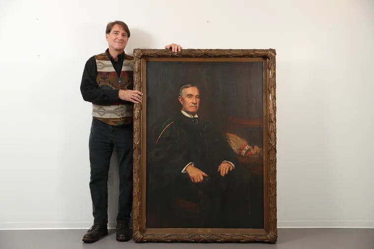 Charles Fox stands by a portrait of his great-uncle, Dr. L. Webster Fox at Jefferson University on Oct. 15, 2019.