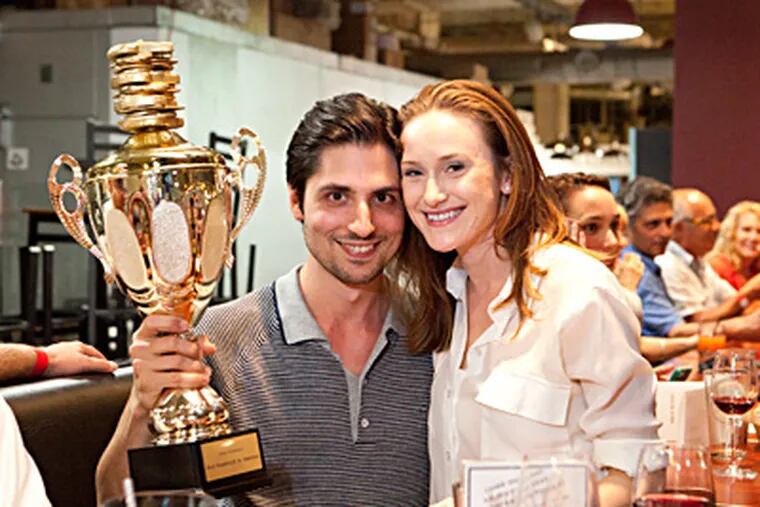 Joe Nicolosi and wife Christina celebrate their Travel Channel "Best Sandwich in America" victory. They won for DiNic's roast pork, served at the family's Reading Terminal Market stand.