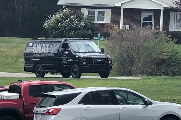 In this photo provided by WJZY, a tactical van from Caldwell County, North Carolina, sat on stand-by at a staging area in Boone, N.C., on Wednesday.