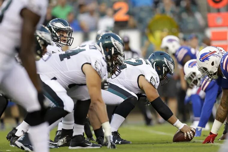 Eagles center Jason Kelce with the football with quarterback Carson Wentz during a preseason game against the Buffalo Bills on August 17.