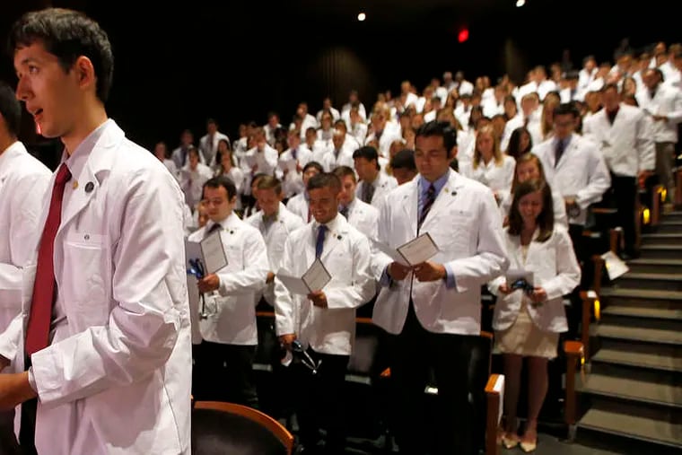 First-year medical students at Penn's Perelman School of Medicine recite the Hippocratic oath during a "white coat ceremony" in Zellerbach Theatre at the Annenberg Center.
